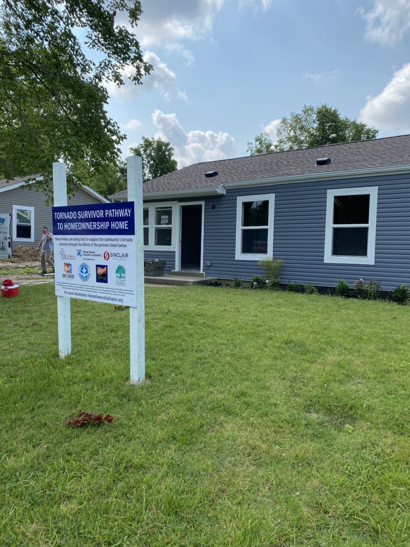 Dayton Tornado Survivors to Home Ownership Sign in front of home.